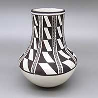 Black-on-white jar with a tall neck and an eight-panel geometric design
 by Anita Lowden of Acoma