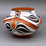 A polychrome jar with a four-panel rainbow and geometric design
 by Delores Aragon Juanico of Acoma