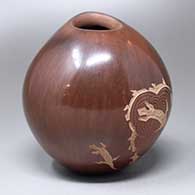 A brown seed pot with an organic opening and two panels of lizards and geometric design
 by Bernice Naranjo of Taos