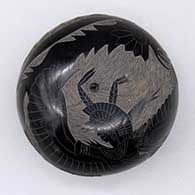 Black seed pot with a sgraffito dancer, avanyu, bear-with-heart-line, and feather ring design
 by Tom Tapia of Ohkay Owingeh