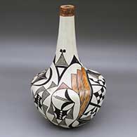 A polychrome jar with a tall thin neck and decorated with a four-panel classic Mimbres geometric design
 by Mary Histia of Acoma
