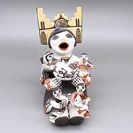 Polychrome storyteller with four children, jar with a lizard design, cat, butterfly, and bird
 by Marilyn Ray of Acoma