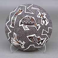 Polychrome seed pot with a fish, bird, lizard, mosquito, caterpillar, and fine line geometric design
 by Rebecca Lucario of Acoma