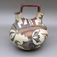 Polychrome wedding vase with a square handle, a traditional Acoma design featuring geometric elements, and two geometric cut hole details; one circular and one triangular
 by Unknown of Acoma