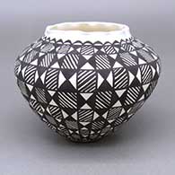 Black-on-white jar with a pie crust opening and a painted fine line and geometric design
 by Sandra Victorino of Acoma