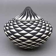 Black-on-white seed pot with a feather ring and geometric design
 by Cletus Victorino of Acoma
