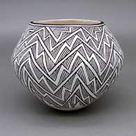 Black-on-white jar with a fine line geometric design
 by Emma Lewis of Acoma
