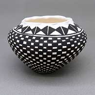Small black-on-white jar with a pie crust opening and a checkerboard and geometric design
 by Sandra Victorino of Acoma