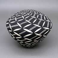 Black-on-white seed pot with a geometric design
 by Cletus Victorino of Acoma