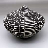 A black-on-white seed pot decorated with a four-panel geometric design
 by Cletus Victorino of Acoma