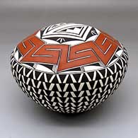 A polychrome seed pot decorated all over with a geometric design
 by Cletus Victorino of Acoma