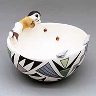 A polychrome bowl decorated with a geometric design on the outside with two birds and boy perched on the rim with a pair of lady bugs inside
 by Judy Lewis of Acoma