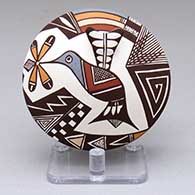 A polychrome seed pot decorated with a hummingbird, flower and geometric design
 by Carolyn Concho of Acoma