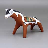A horse decorated with a painted blanket design
 by Clifford Kim Fragua of Jemez