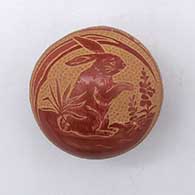 Miniature red seed pot with a sgraffito rabbit, plant, and geometric designJ10
 by Rosemary Lonewolf of Santa Clara
