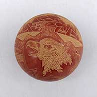 Miniature red seed pot with sgraffito eagle, lightning bolt, storm cloud, and geometric design
 by Susan Romero of Santa Clara