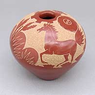 Small red seed pot with a sgraffito horse, sun face, yucca flower, cloud, and desert vegetation design
 by Goldenrod of Santa Clara
