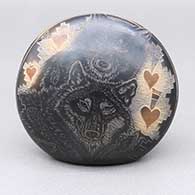 Black seed pot with sienna spots and a sgraffito wolf, avanyu, feather ring, heart, bear paw, and geometric design
 by Kevin Naranjo of Santa Clara