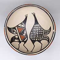 Large polychrome dough bowl with a Mimbres bird design on inside and a geometric design on outside
 by Paulita Pacheco of Santo Domingo