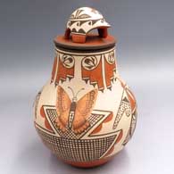 Polychrome jar with a 4-panel moth, butterfly and geometric design around the outside and a turtle on the lid
 by Elizabeth Medina of Zia