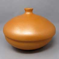 A lidded golden micaceous bean pot