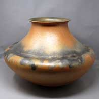 Double shouldered golden micaceous jar with a flared rim and fire clouds