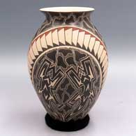 A polychrome jar with a rolled lip and a sgraffito and painted geometric design