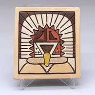 A polychrome tile with a lightly-carved, sgraffito and painted sun katsina and geometric design