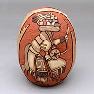 A polychrome seed pot with a two-panel carved and painted kachina dancer and geometric design