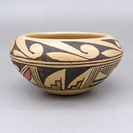 A polychrome bowl decorated with a geometric design and fire clouds