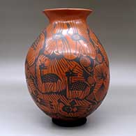 A black on red jar with a flared rim and decorated with a Mimbres wildlife and geometric design