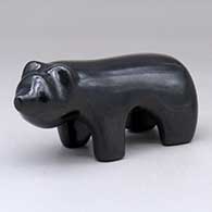 A highly polished black bear figure