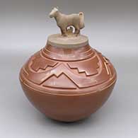 Red lidded jar with sgraffito and carved geometric design and matching lid with a sculpted horse applique