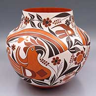 A polychrome jar with a 3-panel parrot, rainbow, branch, flower and geometric design