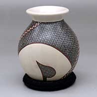 A small jar with a flared rim and decorated with a two-panel geometric design