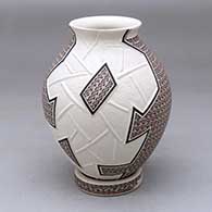 A polychrome jar decorated with a lightly carved and painted geometric design, plus a custom matching stand