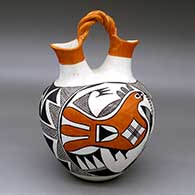 A polychrome wedding vase with a twisted bridge and decorated with a parrot, plant, fine line and geometric design