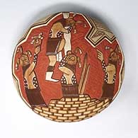 A polychrome seed pot decorated with sgraffito-and-painted mudhead figures, bricks and geometric design