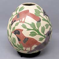 A polychrome jar decorated with sgraffito and painted bird, leaf and branch design