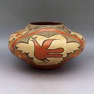 A polychrome jar decorated with a butterfly, bird, flower, and geometric design