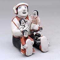 A sitting grandfather storyteller with four children