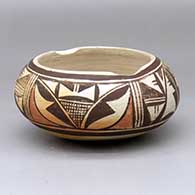 A polychrome tourist market bowl decorated with a four-panel geometric design around the body