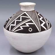 A black-on-white jar with a flared rim and a 4-panel geometric design