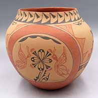 A polychrome jar decorated with a 4-panel butterfly, flower and geometric design