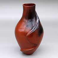 A brown vase with fire clouds and a carved wavy line on one side