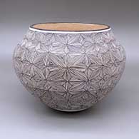 Black-on-white jar with a fine line snowflake and geometric design