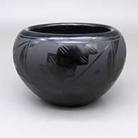 A black-on-black bowl decorated with a four-panel kiva step and geometric design