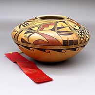 A polychrome seed pot decorated with a four-panel geometric design, Second Place Ribbon from Santa Fe Indian Market 1982