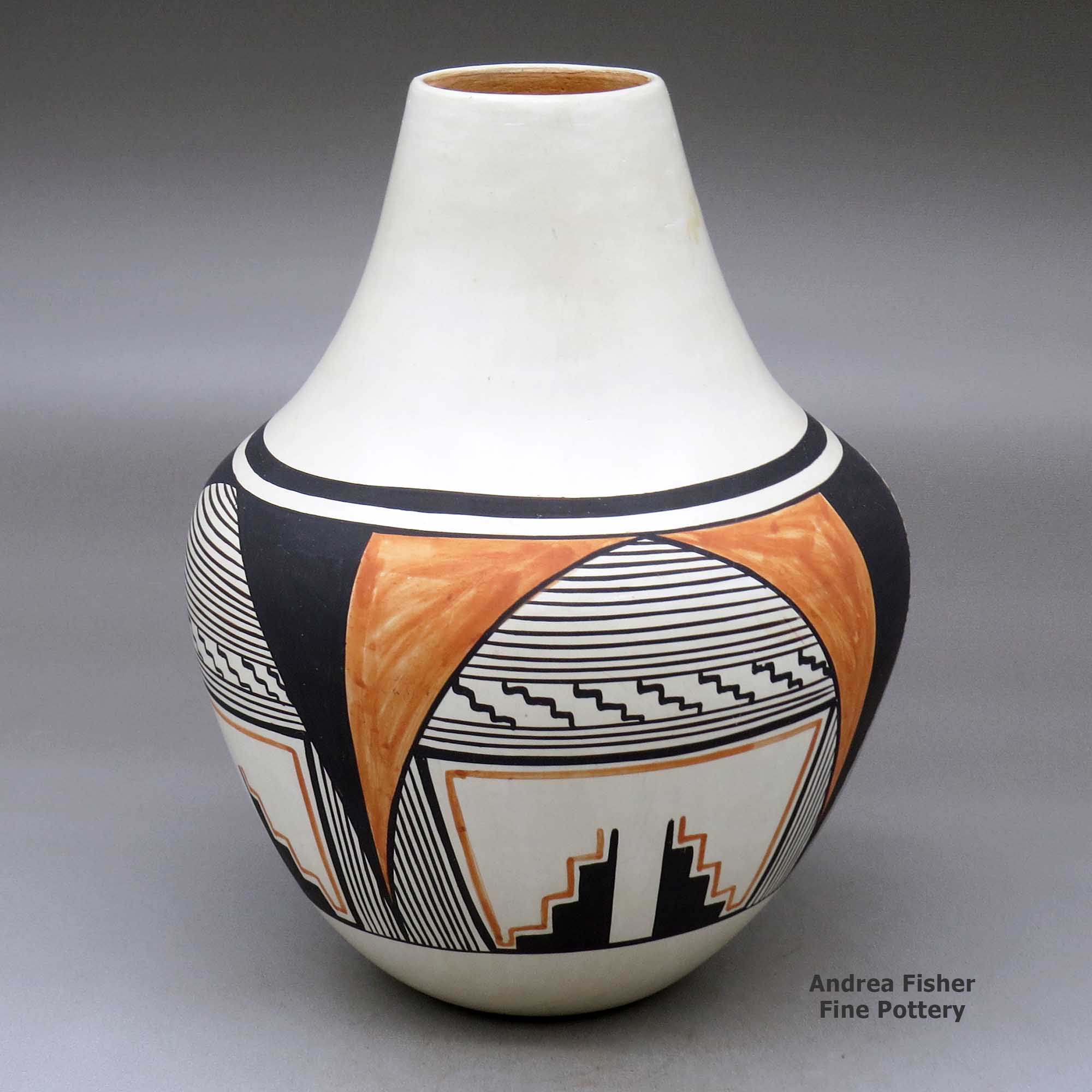 Click or tap to see a larger view A polychrome jar decorated with a four-panel geometric design around the body made by Eunice Navasie of Hopi