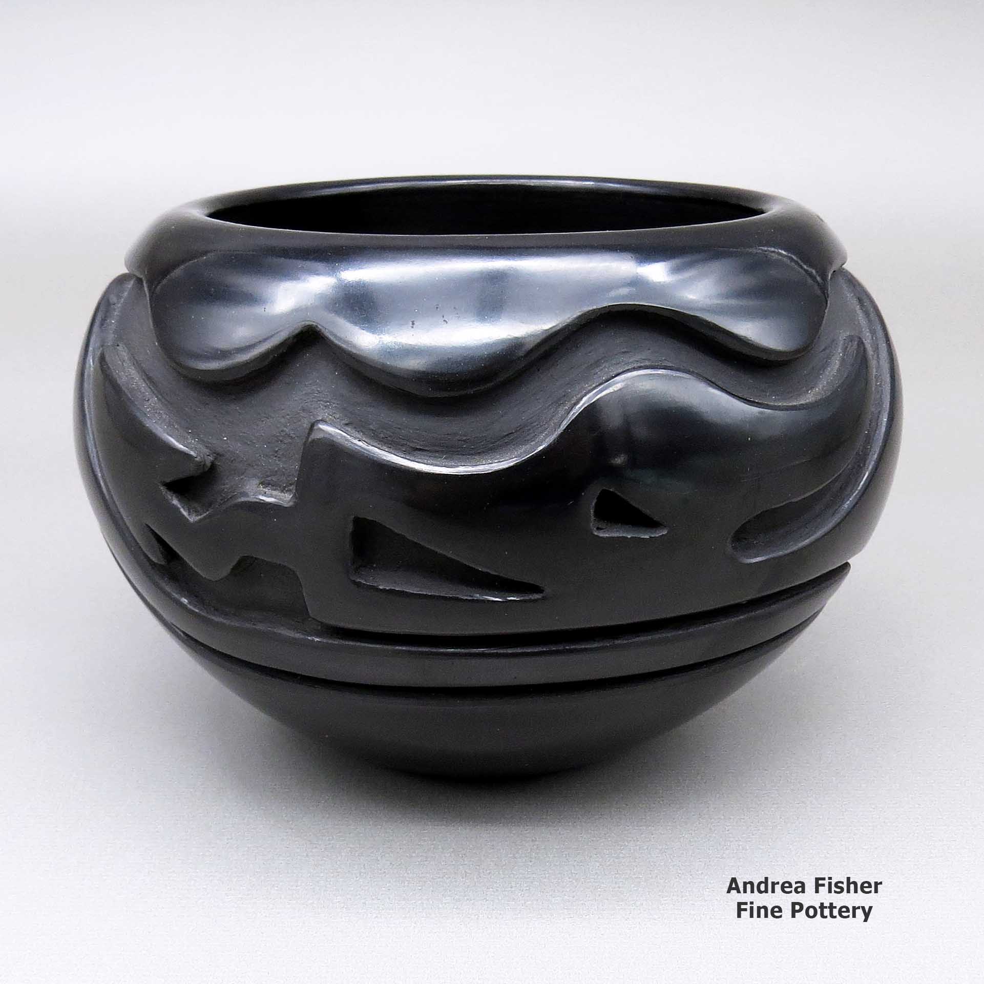 Click or tap to see a larger view Black bowl with a carved avanyu design made by Stella Chavarria of Santa Clara